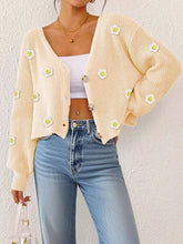 Women's floral appliqué cardigan styled as a cropped layering piece