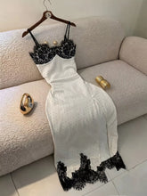 Women's long white polka dot dress with spaghetti straps and lace detail
